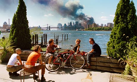 Young people chat as the World Trade Centre smokes in the background